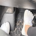 Person wearing white gloves working on mechanical equipment with metal grating