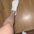 Person wearing white toe socks on wooden floor