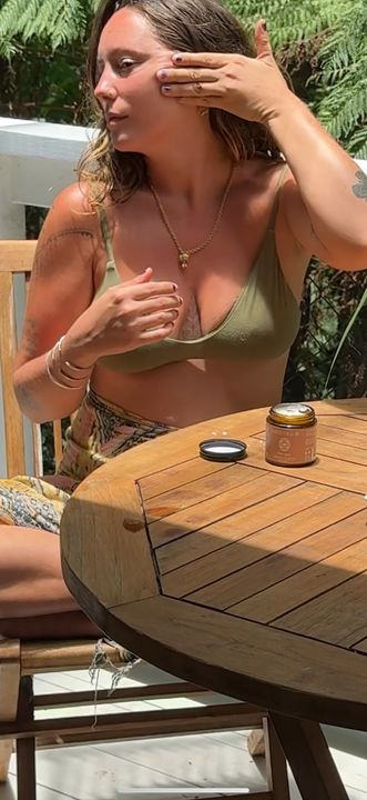 Grace wearing an Olive Stella bra at an outdoor table