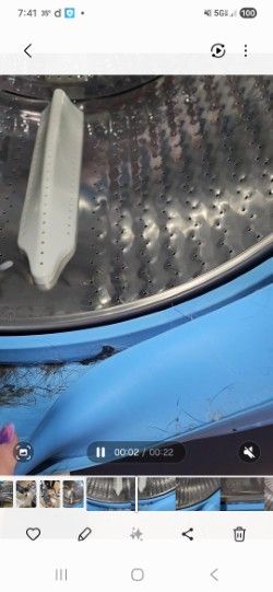 Interior of a boat hull showing metal surface with rivets and blue painted exterior edge
