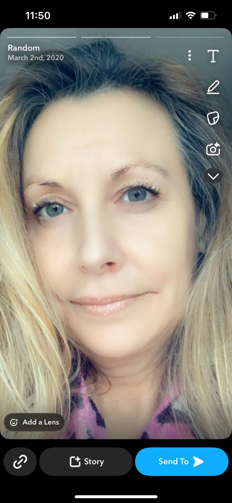 A woman with blonde hair and blue eyes taking a selfie, shown in what appears to be a social media app interface